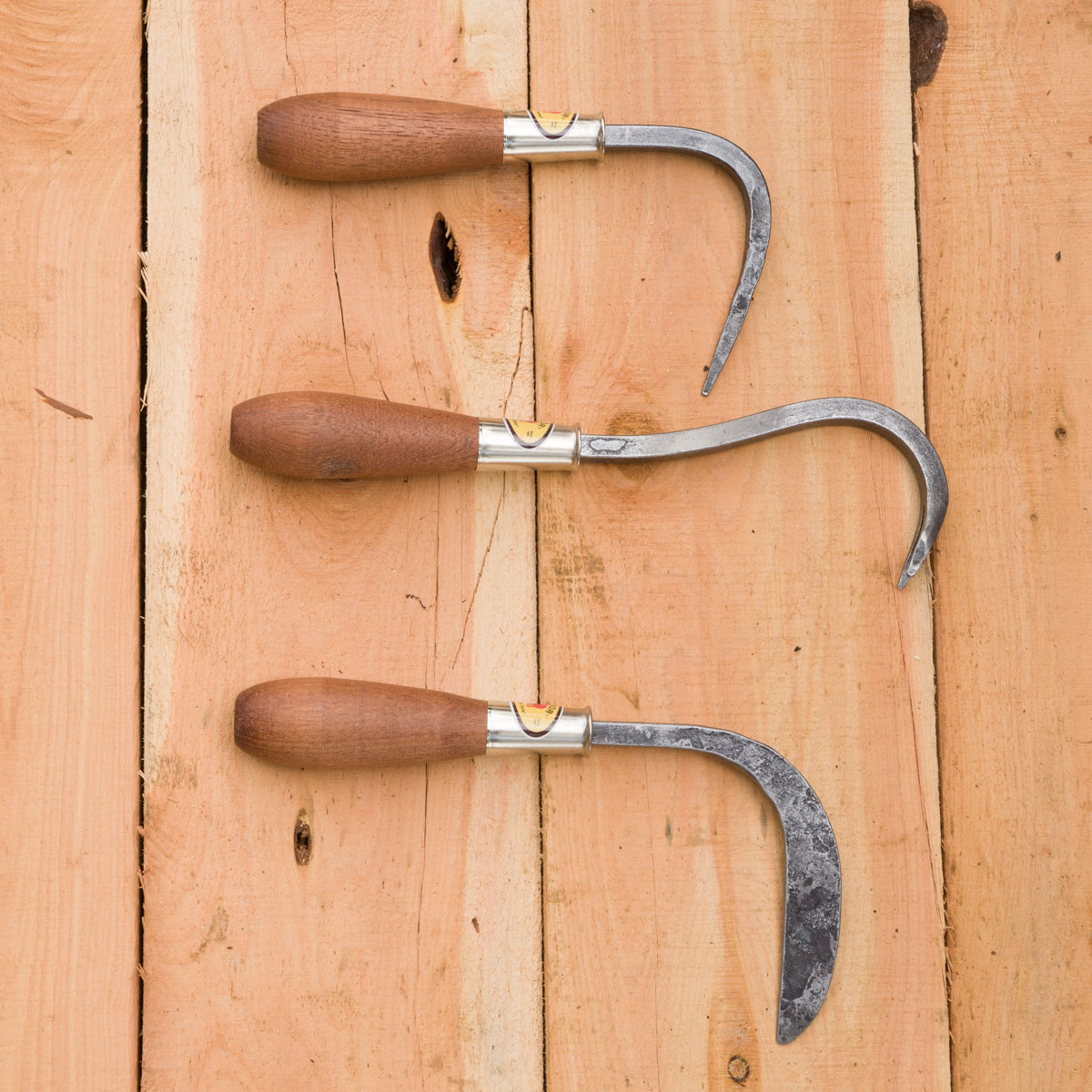 From top to bottom: root hook, weed yank, crevice weeder