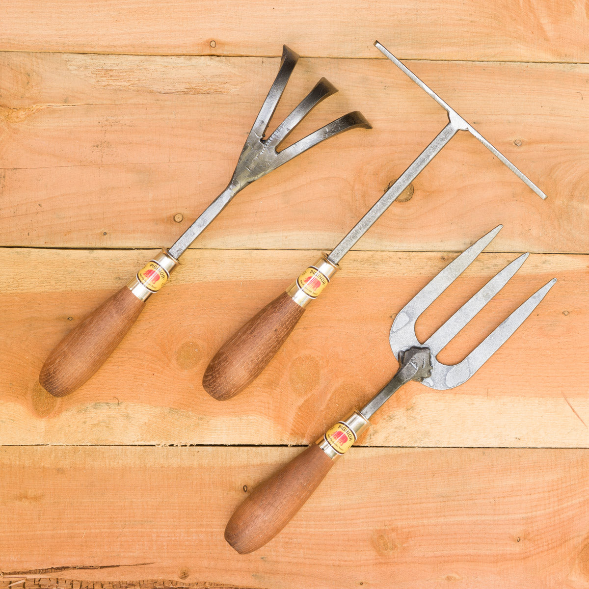 Pictured from left to right: Three-Tine Cultivator, Hand Rake, English Fork