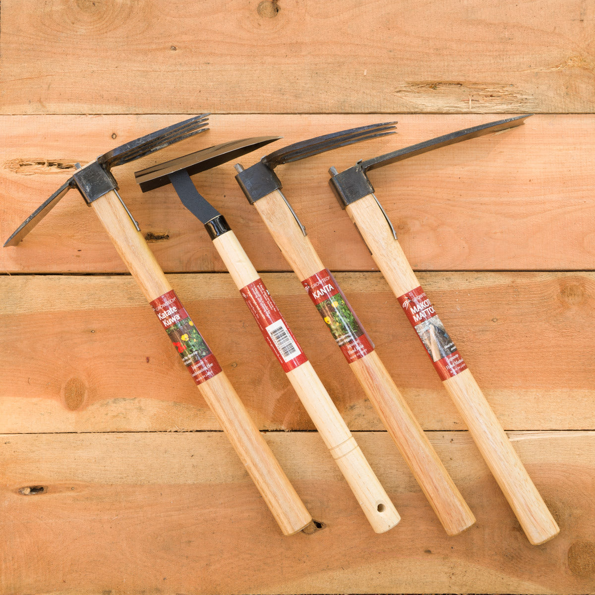 From left to right: Japanese Combo Hoe (Katate Kuwa), Japanese Triangle Hoe (Sankaku Kuwa), Japanese Hand Rake (Kanta), Japanese Hand Mattock (Makoto Mattock)