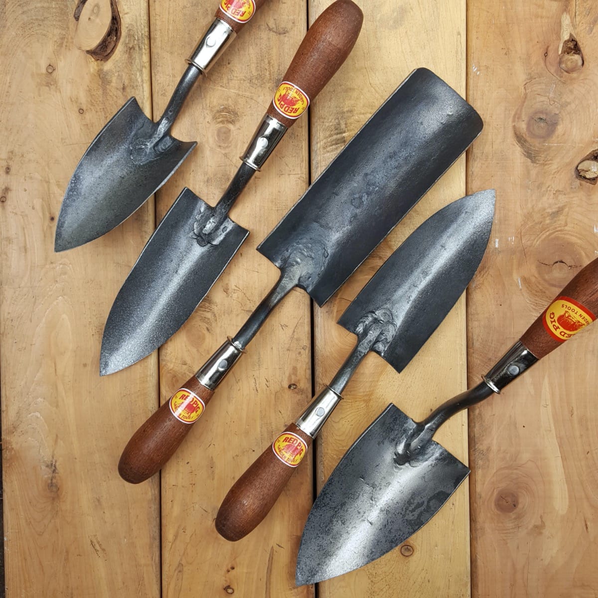 Collection of Red Pig trowels: small, medium, bigger holeabout, holeabout, large