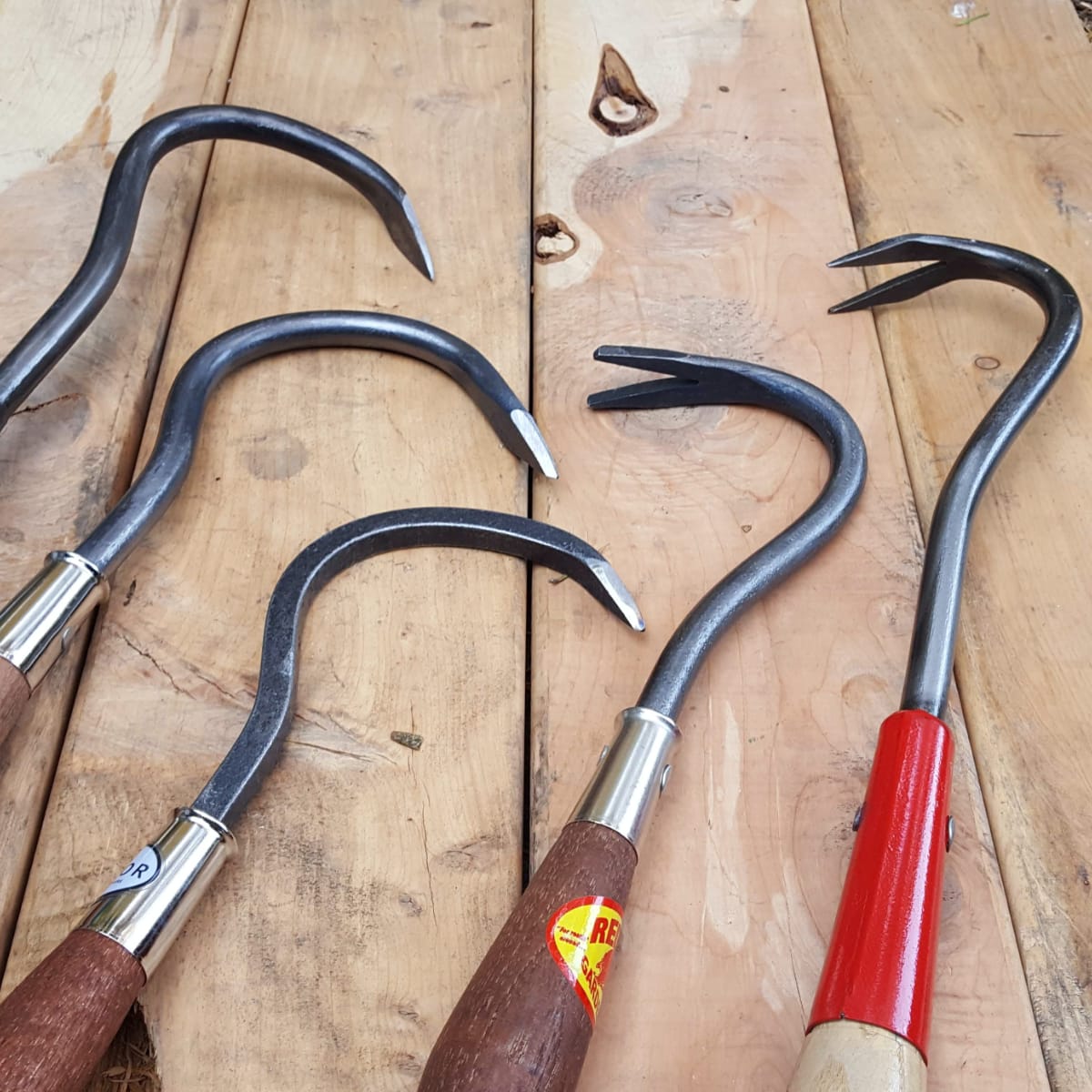 Finger hoes, or single tine cultivator, at left compared to various weed yanks at right.